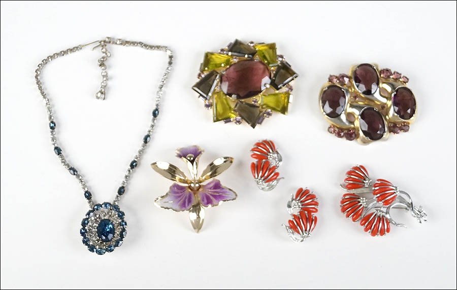 AN ALICE CAVINESS PURPLE AND MULTI-COLORED GLASS: AN ALICE CAVINESS PURPLE AND MULTI-COLORED GLASS BROOCH. Together with a Christian Dior for Kramer blue and white rhinestone necklace, an unsigned purple rhinestone brooch, an enamel orchid brooch, an