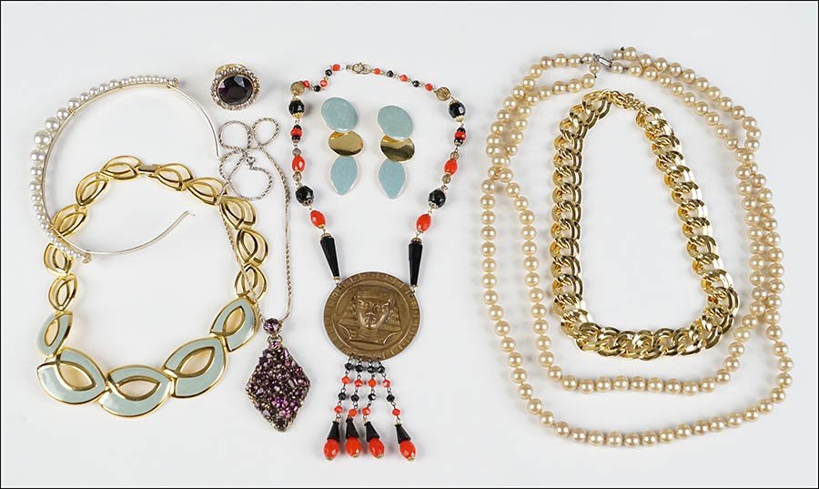 A KRAMER PURPLE RHINESTONE PENDANT NECKLACE.: A KRAMER PURPLE RHINESTONE PENDANT NECKLACE. Together with a purple and white rhinestone cocktail ring, a Napier blue enamel and gold tone necklace and earrings, a faux pearl headband, an Egyptian sty