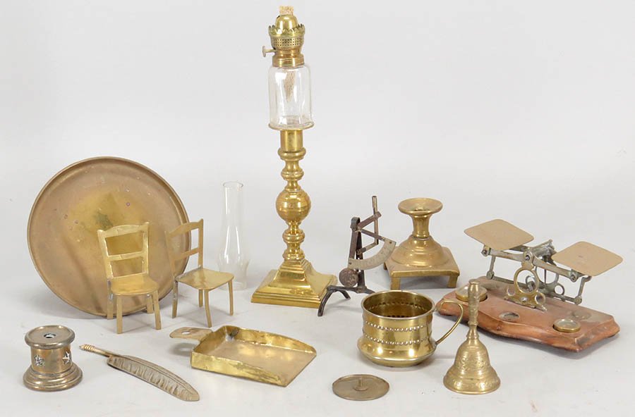 COLLECTION OF BRASS TABLE ARTICLES.: COLLECTION OF BRASS TABLE ARTICLES. Comprised of a scale mounted on a wood base, a candlestick form oil lamp, an Indian bell, a candlestick, a dish, two miniature chairs, a scoop, and three brass over