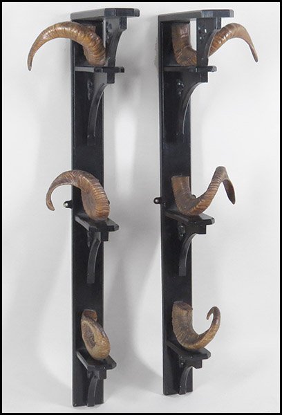 A PAIR OF ENGLISH GUN RACKS.: A PAIR OF ENGLISH GUN RACKS. Ebonized wood and ram's horns Length: 43"