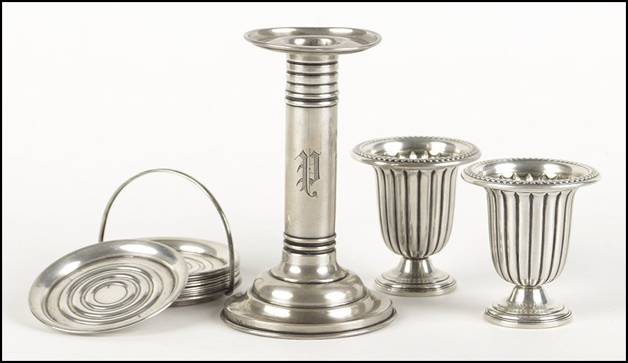 A SET OF TEN STERLING SILVER COASTERS.: A SET OF TEN STERLING SILVER COASTERS. With a sterling basket style carrier. Together with a pair of LaPierre weighted sterling silver footed cups, and a weighted sterling silver candlestick Weight of