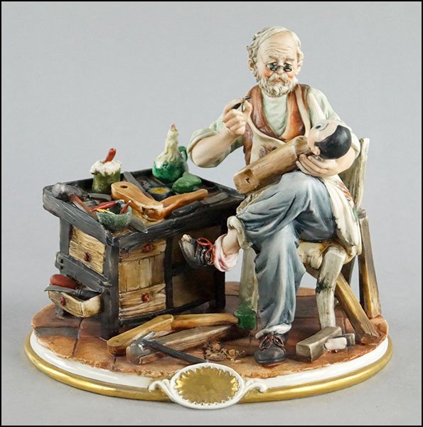 CAPODIMONTE PORCELAIN FIGURE DEPICTING GEPETTO IN HIS: CAPODIMONTE PORCELAIN FIGURE DEPICTING GEPETTO IN HIS WORKSHOP. Bearing Capodimonte seal on the base 8" x 8.5" x 6.5"
