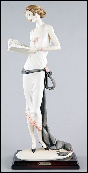 GIUSEPPE ARMANI FIGURE OF A LADY WITH A BOOK.: GIUSEPPE ARMANI FIGURE OF A LADY WITH A BOOK. Mounted on a base, bearing artist signature and Capodimonte mark, includes original box 17.5" x 8" x 5"