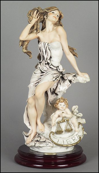 GIUSEPPE ARMANI 'LIBRA' FIGURE.: GIUSEPPE ARMANI 'LIBRA' FIGURE. From the Zodiac series. Signed on the sculpture. Edition no. 979/5000. Copyright Florence 1998. Bearing the Capodimonte 'N' crown stamp. Raised on a wood base (H: 1.25'