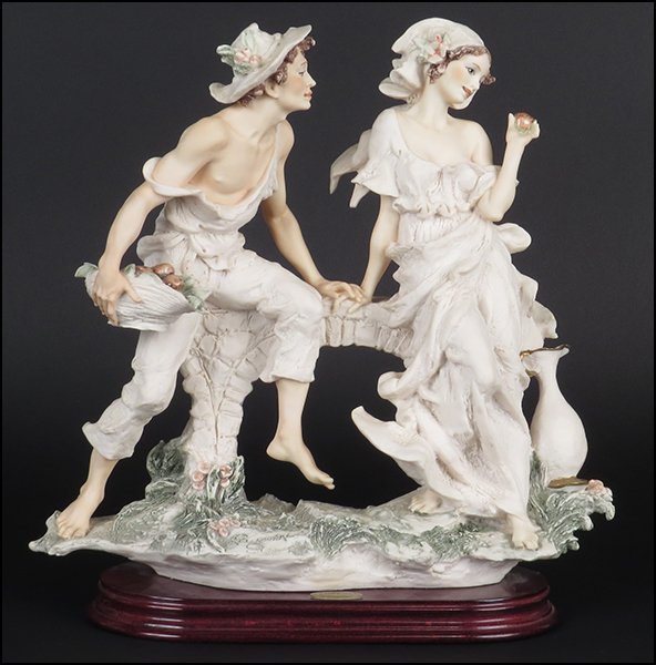 GIUSEPPE ARMANI 'SWEET APPLE' FIGURAL GROUP.: GIUSEPPE ARMANI 'SWEET APPLE' FIGURAL GROUP. Signed on the sculpture. Copyright Florence 1995. Bearing the Capodimonte 'N' crown stamp. Raised on a wood base (1'' x 9.5'' x 5''). With original box H: