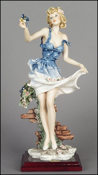 GIUSEPPE ARMANI 'LOVE IN BLOOM' FIGURE.: GIUSEPPE ARMANI 'LOVE IN BLOOM' FIGURE. Signed on the sculpture. Copyright Florence 1995. Bearing the Capodimonte 'N' crown stamp. Raised on a wood base (.75'' x 5.25'' x 5.25''). With original box Fi