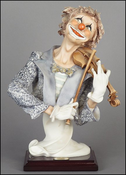 GIUSEPPE ARMANI 'CLOWN BUST WITH VIOLIN' FIGURE.: GIUSEPPE ARMANI 'CLOWN BUST WITH VIOLIN' FIGURE. Signed on the sculpture. Edition no. 1479/5000. Copyright Florence 1990. Bearing the Capodimonte 'N' crown stamp. Raised on a wood base (.75'' x 5.25''