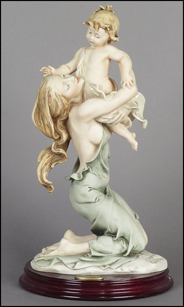 GIUSEPPE ARMANI 'KNELT MATERNITY' FIGURE.: GIUSEPPE ARMANI 'KNELT MATERNITY' FIGURE. Signed on the sculpture. Copyright Florence 1992. Bearing the Capodimonte 'N' crown stamp. Raised on a wood base (H: 1'' Diameter: 6.75''). With original box