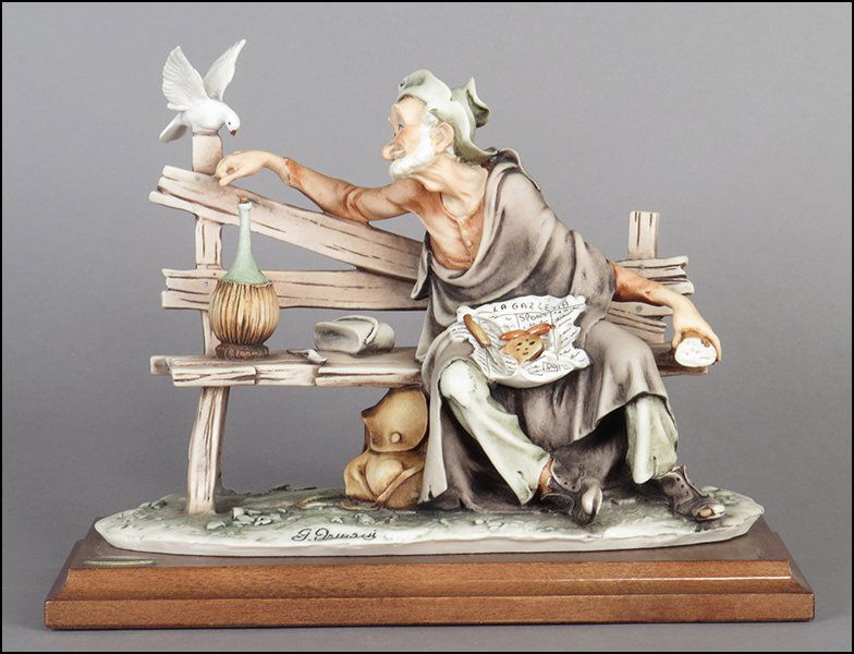 GIUSEPPE ARMANI 'TRAMP FEEDING DOVE' FIGURAL GROUP.: GIUSEPPE ARMANI 'TRAMP FEEDING DOVE' FIGURAL GROUP. Signed on the sculpture. Made in Italy. Bearing the Capodimonte 'N' crown stamp. Raised on a wood base (.75'' x 10.5'' x 5''). With original box Fig