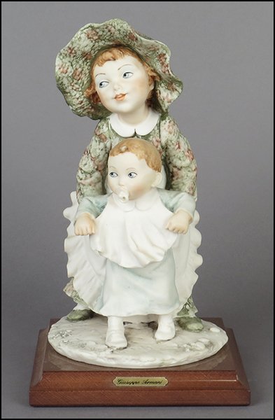 GIUSEPPE ARMANI 'FIRST STEPS' FIGURAL GROUP.: GIUSEPPE ARMANI 'FIRST STEPS' FIGURAL GROUP. Signed on the sculpture. Copyright Florence 1994. Bearing the Capodimonte 'N' crown stamp. Raised on a wood base (1'' x 5.25'' x 5.25''). With original box