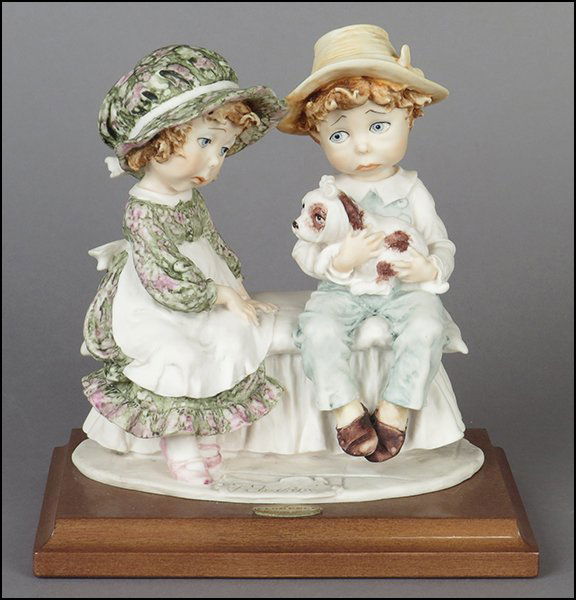 GIUSEPPE ARMANI 'UNDER THE WEATHER ILL PUPPY' FIGURAL: GIUSEPPE ARMANI 'UNDER THE WEATHER ILL PUPPY' FIGURAL GROUP. Signed on the sculpture. Copyright Florence 1982. Bearing the Capodimonte 'N' crown stamp. Raised on a wood base (1'' x 7.25'' x 5''). With