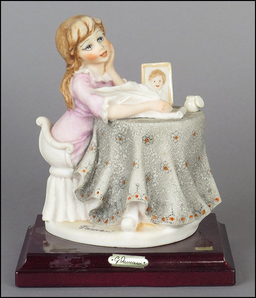 GIUSEPPE ARMANI 'LOVE LETTERS' FIGURE.: GIUSEPPE ARMANI 'LOVE LETTERS' FIGURE. Signed on the sculpture. Copyright Florence 1987. Bearing the Capodimonte 'N' crown stamp. Raised on a wood base (1'' x 6'' x 4.25''). With original box Figure H