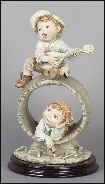 GIUSEPPE ARMANI 'THE BARREL' FIGURE.: GIUSEPPE ARMANI 'THE BARREL' FIGURE. Signed on the sculpture. Edition no. 395/1000. Bearing the Capodimonte 'N' crown stamp. Raised on a wood base (H: 1.25'' Diameter: 6.75''). With original box Figur