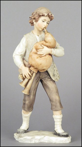 GIUSEPPE ARMANI 'BAGPIPE PLAYER' FIGURE.: GIUSEPPE ARMANI 'BAGPIPE PLAYER' FIGURE. Signed on the sculpture. Copyright Florence 1983. Bearing the Capodimonte 'N' crown stamp. With original box Figure H: 10.5''
