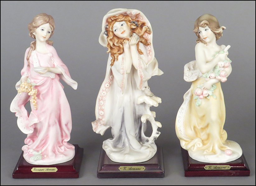 GROUP OF THREE GIUSEPPE ARMANI FIGURES.: GROUP OF THREE GIUSEPPE ARMANI FIGURES. Comprised of three figures of young ladies in various poses. All are signed on the sculpture. All bear the Capodimonte 'N' crown stamp. All are raised on wood b