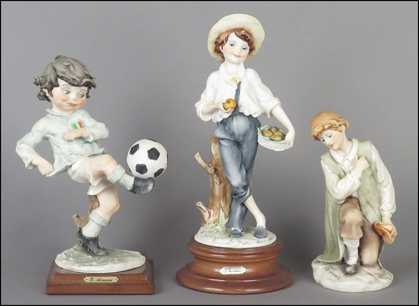 GROUP OF THREE GIUSEPPE ARMANI MALE FIGURES.: GROUP OF THREE GIUSEPPE ARMANI MALE FIGURES. Comprised of 'Boy Kicking Soccer Ball,' 'Boy Picking Apples,' and 'Young Man Kneeling.' All bear signature on sculpture. Two are raised on bases. One comes