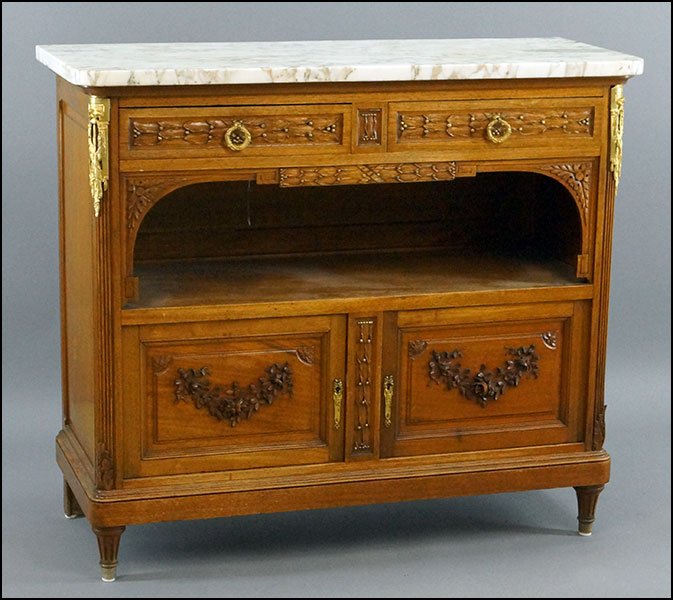 CARVED WALNUT MARBLE TOP SIDEBOARD.: CARVED WALNUT MARBLE TOP SIDEBOARD. Ormolu mounted with a foliate motif and gilt accents bearing two drawers and two doors 41" x 47" x 18.5"