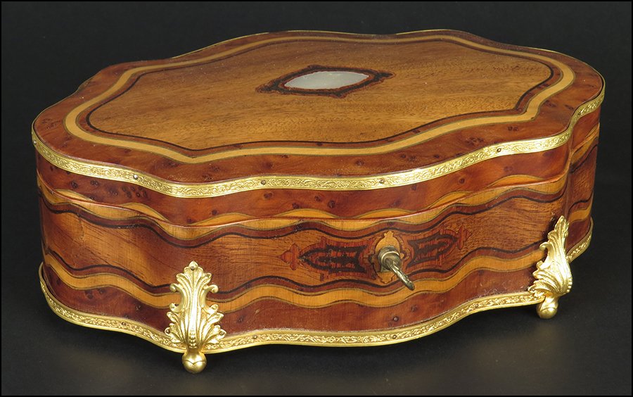 FRENCH CARVED MAPLE AND LEMON WOOD JEWELRY BOX.: FRENCH CARVED MAPLE AND LEMON WOOD JEWELRY BOX. Bearing ormolu mounts and a scalloped edge design. Interior is lined with silk and velvet. Key is included 3'' x 9'' x 5.5''