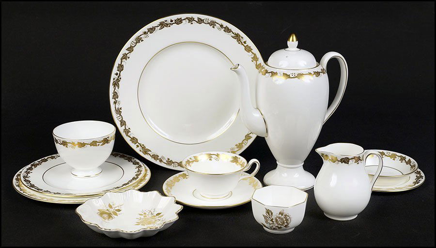 WEDGWOOD GILT PORCELAIN DINNER SERVICE.: WEDGWOOD GILT PORCELAIN DINNER SERVICE. In the Whitehall pattern. Comprised of one shell form dish, ten teacups, nine saucers, eight bread plates, eight salad plates, eight dessert plates, nine dinner