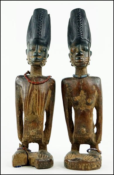 PAIR OF AFRICAN CARVED WOOD IBEJI TWIN FIGURES.: PAIR OF AFRICAN CARVED WOOD IBEJI TWIN FIGURES. Bearing beaded necklaces and matching ankle bracelets Each H: 11.75''