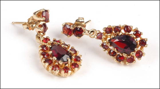 A PAIR OF GARNET AND 14 KARAT YELLOW GOLD EARRINGS. 6.7: A PAIR OF GARNET AND 14 KARAT YELLOW GOLD EARRINGS. 6.7 grams $200/$400