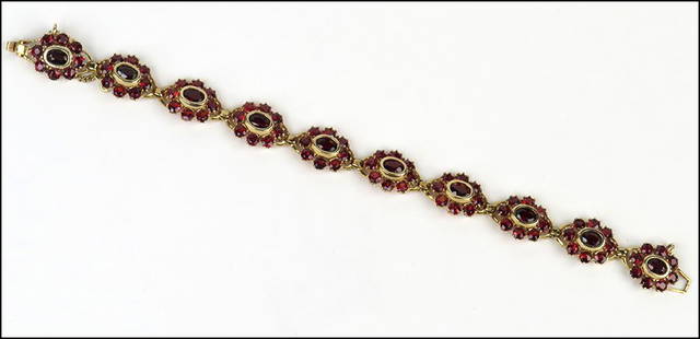 A GARNET AND 14 KARAT YELLOW GOLD BRACELET. Wt: 19: A GARNET AND 14 KARAT YELLOW GOLD BRACELET. Wt: 19 grams Length: 7" $300/$500