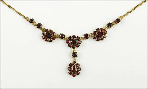 A GARNET AND 14 KARAT YELLOW GOLD NECKLACE. Length: 17": A GARNET AND 14 KARAT YELLOW GOLD NECKLACE. Length: 17" Wt: 10.8 grams $400/$600 Clasp is 18 karat yellow gold