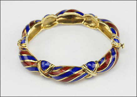 AN ENAMEL AND 14 KARAT YELLOW GOLD BANGLE BRACELET. Wt:: AN ENAMEL AND 14 KARAT YELLOW GOLD BANGLE BRACELET. Wt: 68.3 grams $2,000/$3,000 Decorated with red and blue alternating enamel. Interior is stamped "Martine 14K"