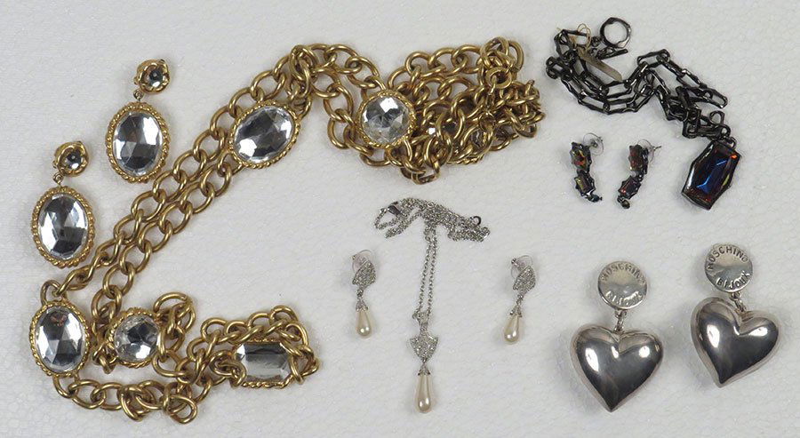CHRISTIAN DIOR NECKLACE AND EARRINGS SET. $100/$200: CHRISTIAN DIOR NECKLACE AND EARRINGS SET. $100/$200 Comprised of silvertone, rhinestones and faux pearls. Together with a DKNY goldtone chain necklace and matching earclips, a pair of Moschino Bijoux