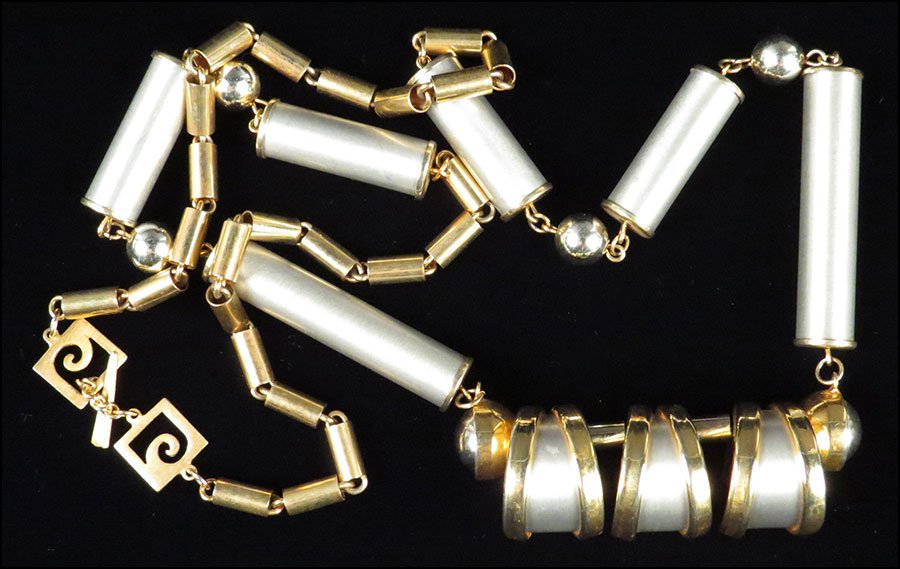 A PIERRE CARDIN 'SPACE AGE' NECKLACE. Length: 38": A PIERRE CARDIN 'SPACE AGE' NECKLACE. Length: 38" $300/$500 Comprising alternating brushed gold tone metal links, brushed silver tone metal links, and polished silver tone balls. Clasp bears signature
