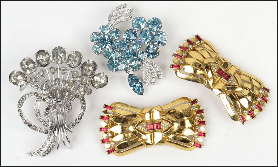 AN EISENBERG STERLING SILVER AND WHITE RHINESTONE: AN EISENBERG STERLING SILVER AND WHITE RHINESTONE BROOCH. $100/$200 Together with an Eisenberg Ice blue and white rhinestone brooch, and a pair of Coro Duette red rhinestone and gold tone metal dress