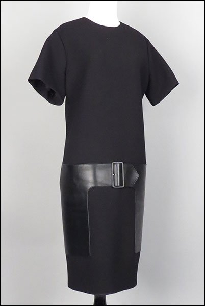 CELINE BLACK WOOL DRESS. Size 44 $75/$125 Bearing: CELINE BLACK WOOL DRESS. Size 44 $75/$125 Bearing leather paneled pockets and a built-in belt. With a silk lining. Made in France. Provenance: From the Estate of Frances R. Dittmer
