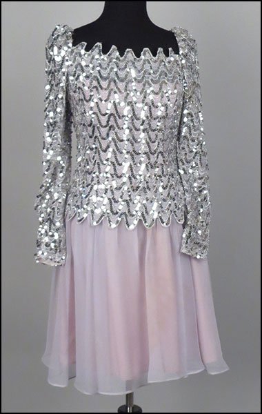 A LEE JORDAN NEW YORK SILVER TONE SEQUIN COCKTAIL: A LEE JORDAN NEW YORK SILVER TONE SEQUIN COCKTAIL DRESS. Size 8 $100/$150 Bearing long sleeves, with a zig zag cut out pattern. With a chiffon skirt bottom. With a zip up back