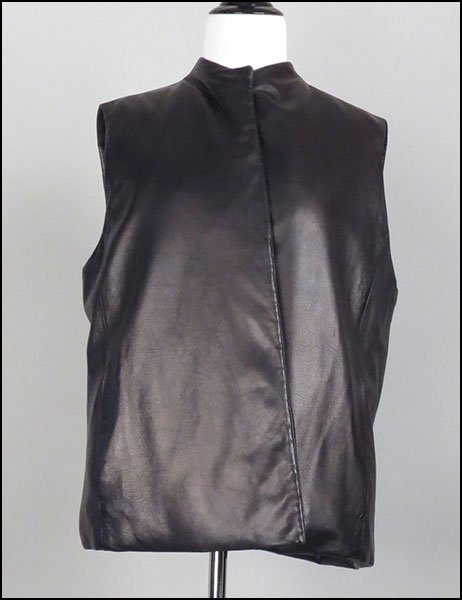 DONNA KARAN SIGNATURE BLACK LAMBSKIN VEST. Vest size US: DONNA KARAN SIGNATURE BLACK LAMBSKIN VEST. Vest size US 12 $150/$250 Lined. With a snap front. Together with a pair of Neiman Marcus black leather pants. Lined (Size 14). Provenance: From the Estate o