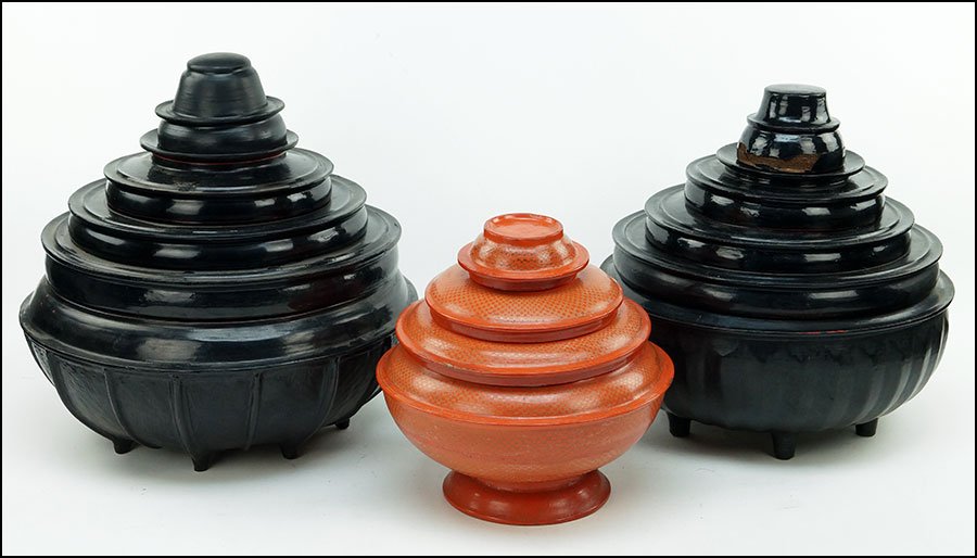 A PAIR OF CHINESE PAPIER-MACHE LACQUERED GRADUATED: A PAIR OF CHINESE PAPIER-MACHE LACQUERED GRADUATED STACKING BOWL AND PLATE SETS. Together with another Chinese papier-mache lacquered graduated stacking bowl and plate set Pair H: 15.75''