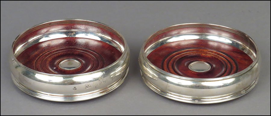 A PAIR OF ENGLISH STERLING SILVER AND WOOD WINE: A PAIR OF ENGLISH STERLING SILVER AND WOOD WINE COASTERS. London, 20th Century Diameter: 5.25''