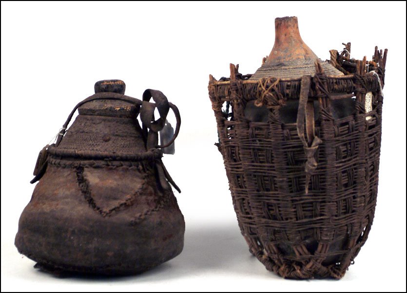 TWO WEST AFRICAN GOURD CONTAINERS.: TWO WEST AFRICAN GOURD CONTAINERS. One with a funnel form top, one with a lid. Both woven Taller H: 17''