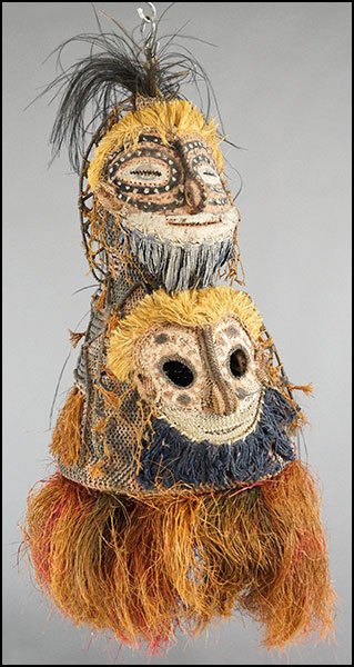 A PAPUA NEW GUINEA CEREMONIAL CLAN MASK.: A PAPUA NEW GUINEA CEREMONIAL CLAN MASK. Bearing a woven body with painted embellishments and a plaster casting over the upper 'face' portion. Two faces depicted 29.5'' x 16'' x 18''