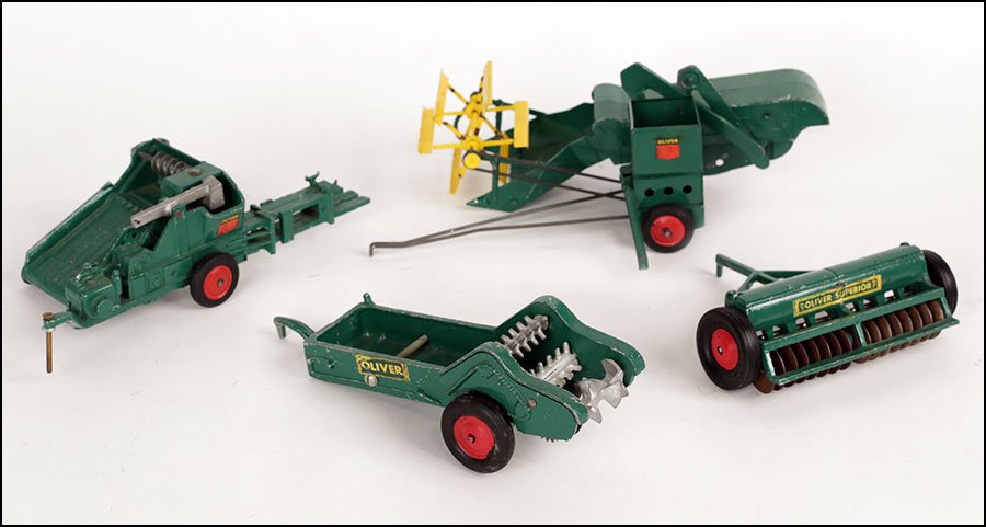 GROUP OF GREEN OLIVER FARM TOYS MADE BY SLIK TOYS.: GROUP OF GREEN OLIVER FARM TOYS MADE BY SLIK TOYS. Comprised of a hay bailer, a disc tiller, a thatcher, and a spreader