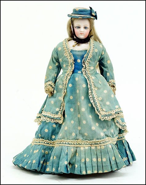 AN EARLY JUMEAU BISQUE DOLL.: AN EARLY JUMEAU BISQUE DOLL. Bearing a hard leather body, with leather fingers. With a moveable head and almond eyes. Marked with an incised 0 H: 12''