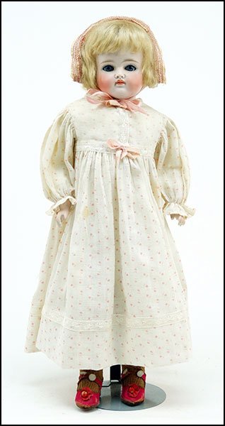 A JUMEAU BISQUE DOLL.: A JUMEAU BISQUE DOLL. Incised with the number 9. Bearing a movable hard leather body with composition hands. Unmarked elsewhere. With set eyes and a closed mouth H: 18''