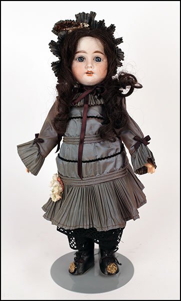A TETE JUMEAU NUMBER THREE FRENCH BISQUE DOLL.: A TETE JUMEAU NUMBER THREE FRENCH BISQUE DOLL. Bearing an open mouth, showing teeth, set eyes, and an eleven piece composition body H: 16''