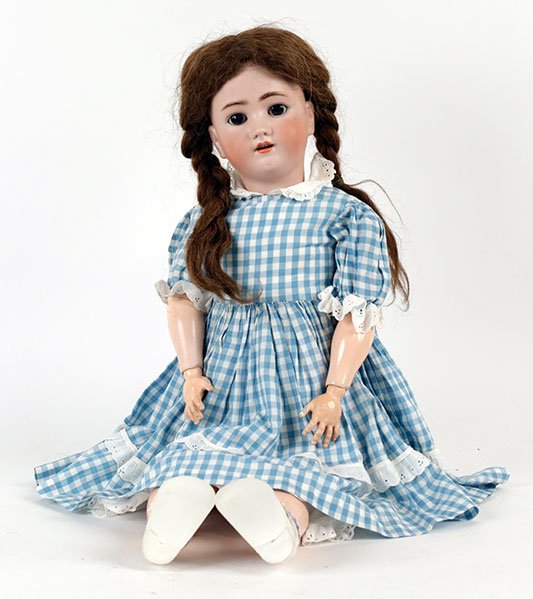 A SIMON & HALBIG HEINRICH HANDWERCK BISQUE PORCELAIN: A SIMON & HALBIG HEINRICH HANDWERCK BISQUE PORCELAIN SOCKET DOLL. Bearing sleepy eyes, an open mouth showing teeth, and an eleven piece composition and wood ball jointed body. Incised with the maker's