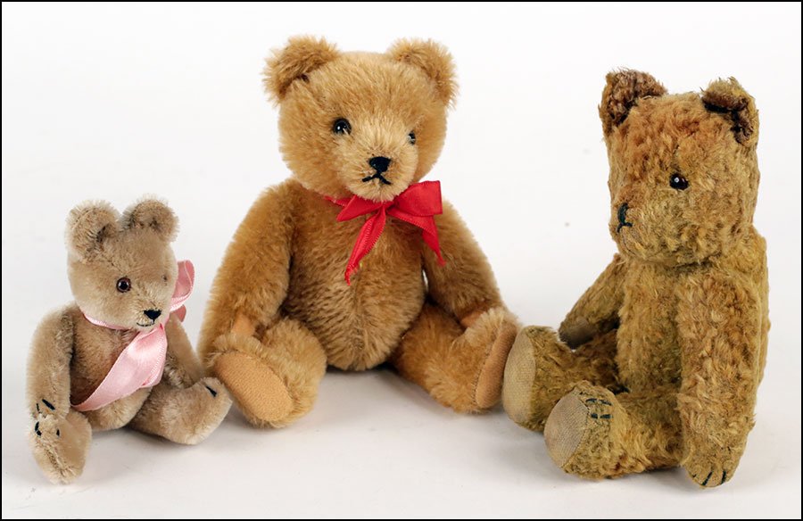 A HERMANN MOHAIR TEDDY BEAR.: A HERMANN MOHAIR TEDDY BEAR. Made in West Germany. With a red bow the neck. Together with a 5'' mohair teddy bear and an antique teddy bear with glass eyes (H: 9''). All with movable limbs Hermman bea
