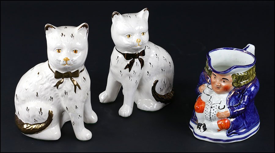 PAIR OF STAFFORDSHIRE SEATED CATS.: PAIR OF STAFFORDSHIRE SEATED CATS. With copper lustre decor. Together with an English Staffordshire porcelain Toby mug Cats Height: 8.5"