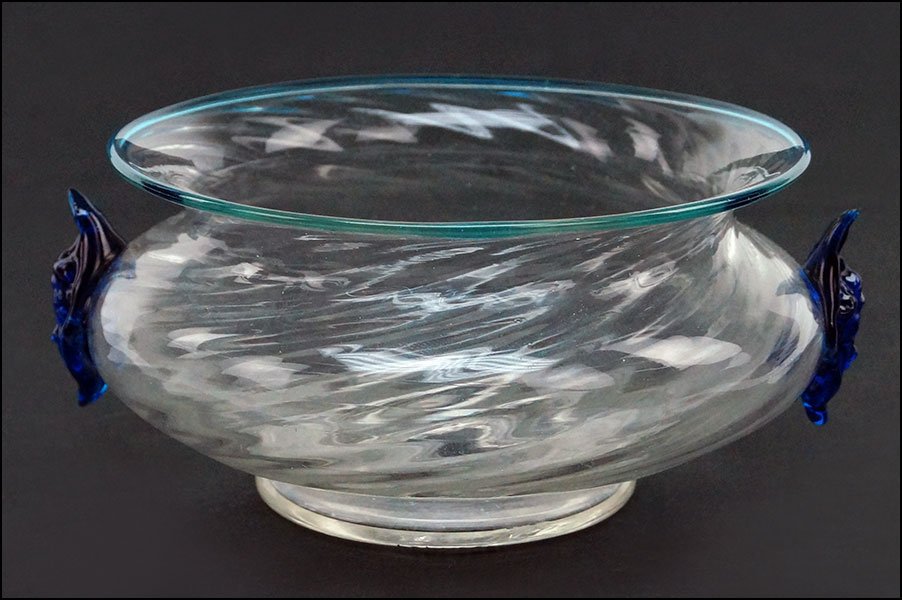 A STEUBEN CLEAR GLASS FINGER BOWL.: A STEUBEN CLEAR GLASS FINGER BOWL. Twisted clear glass finger bowl bears blue handles that depict cherub faces. Rim of bowl is trimmed in light blue. Sold by The Art Institute of Chicago 2" x 5"