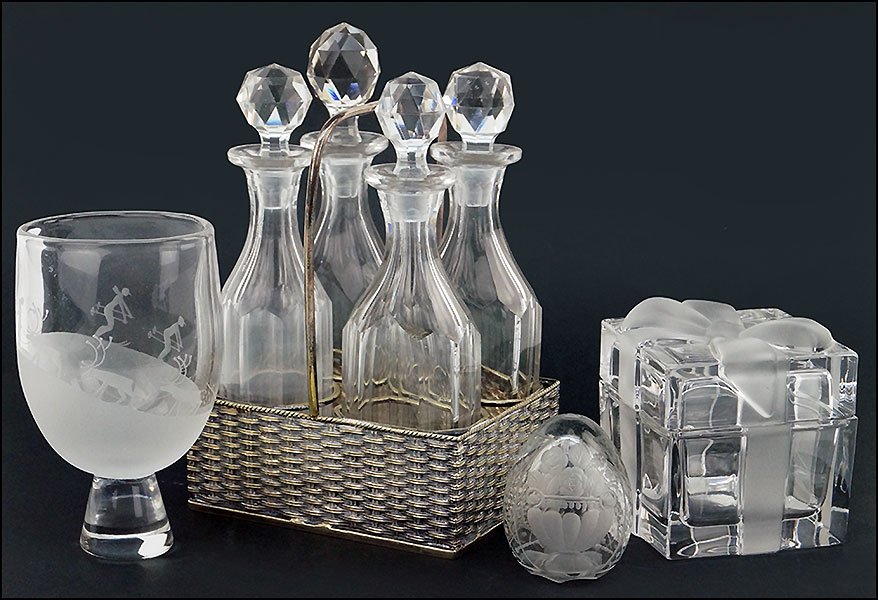 A TIFFANY & COMPANY CRYSTAL 'PRESENT' BOX.: A TIFFANY & COMPANY CRYSTAL 'PRESENT' BOX. Together with an Orrefors goblet decorated with reindeer and skiers, an etched glass egg, and a cruet set