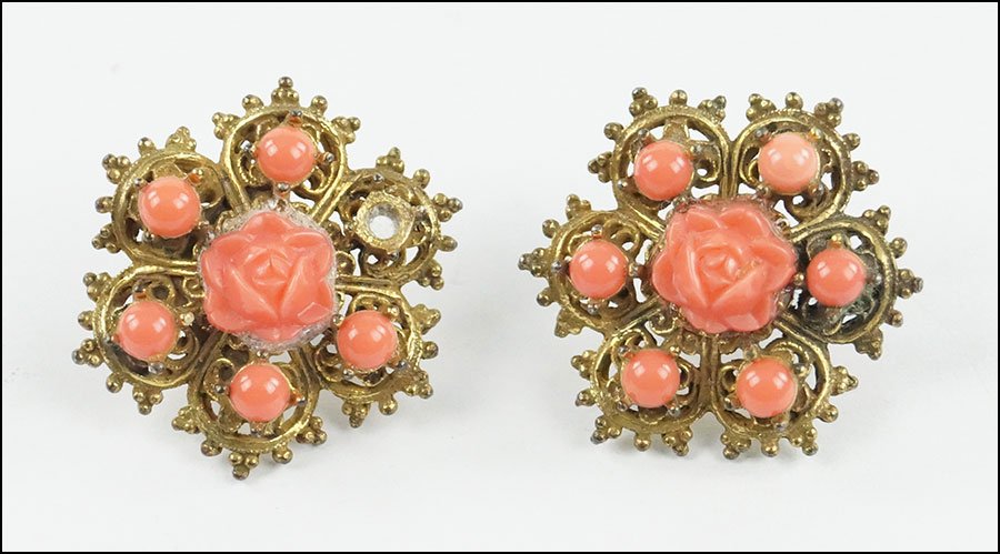 A PAIR OF CARVED CORAL SCREWBACK EARRINGS.: A PAIR OF CARVED CORAL SCREWBACK EARRINGS. Diameter: 1.25"