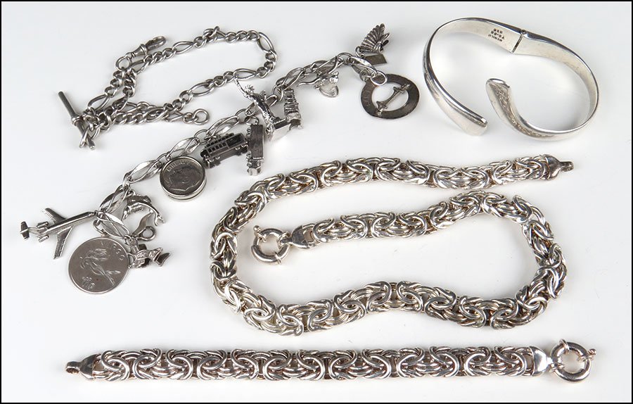 A STERLING SILVER DEMI-PARURE.: A STERLING SILVER DEMI-PARURE. Comprising a necklace and bracelet. Together with a sterling silver cuff bracelet, an English silver watch chain, and a silver charm bracelet
