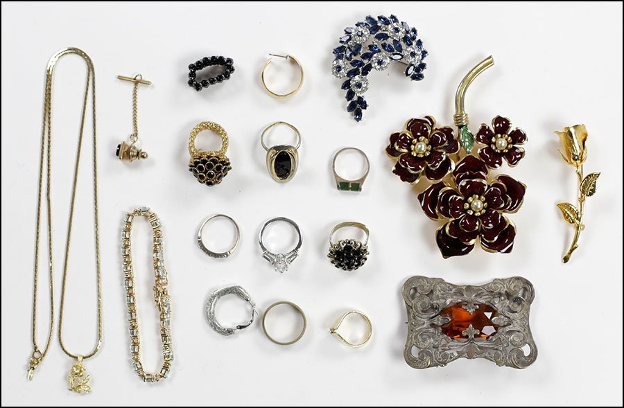 A COLLECTION OF COSTUME JEWELRY.: A COLLECTION OF COSTUME JEWELRY. Comprising a Trifari faux sapphire and white rhinestone brooch, a gold tone flower brooch, an enamel and faux pearl flower brooch, an art nouveau faux citrine brooch,